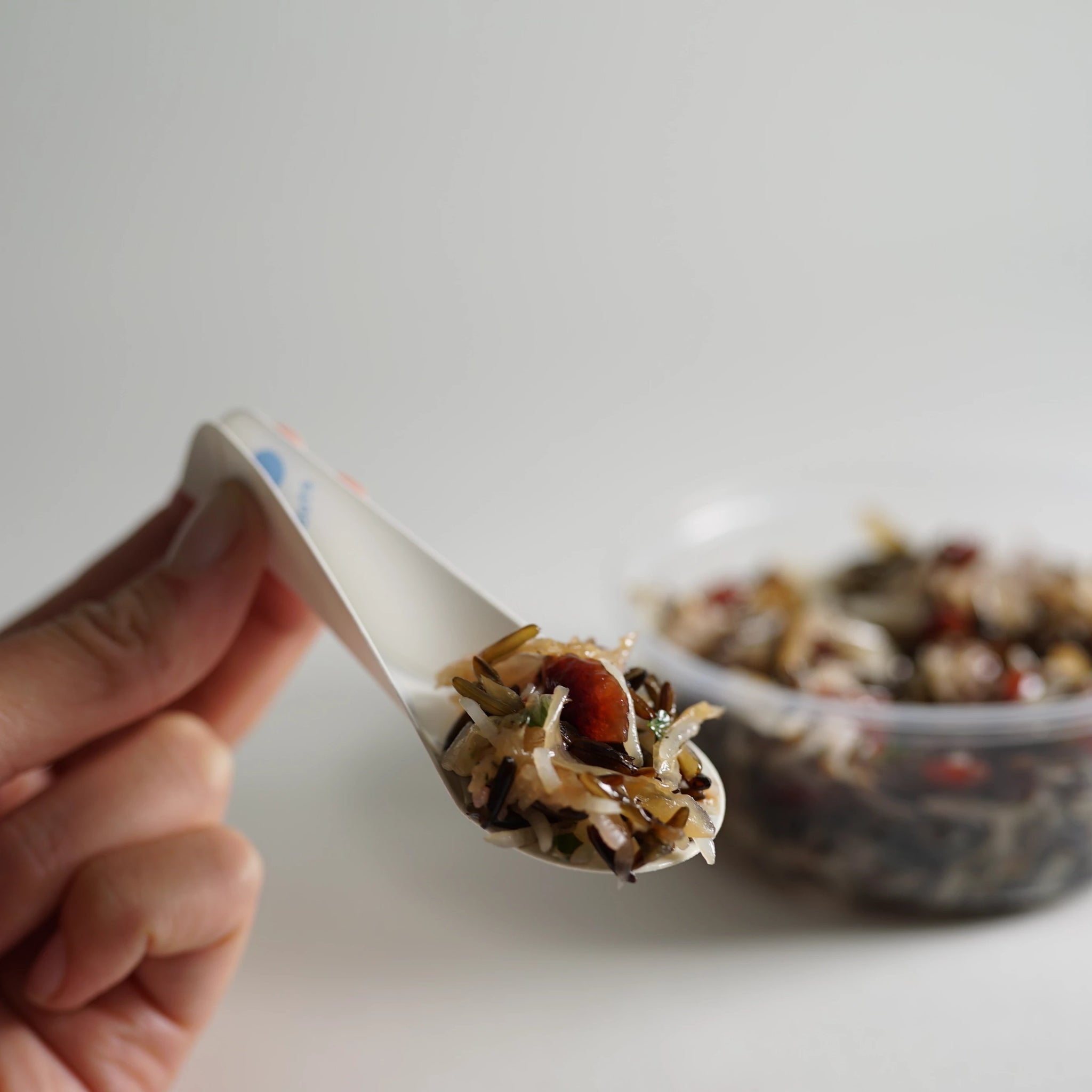 The EcoSpoon4 is eco friendly cutlery, about 4” long, shown with full servings of muesli.