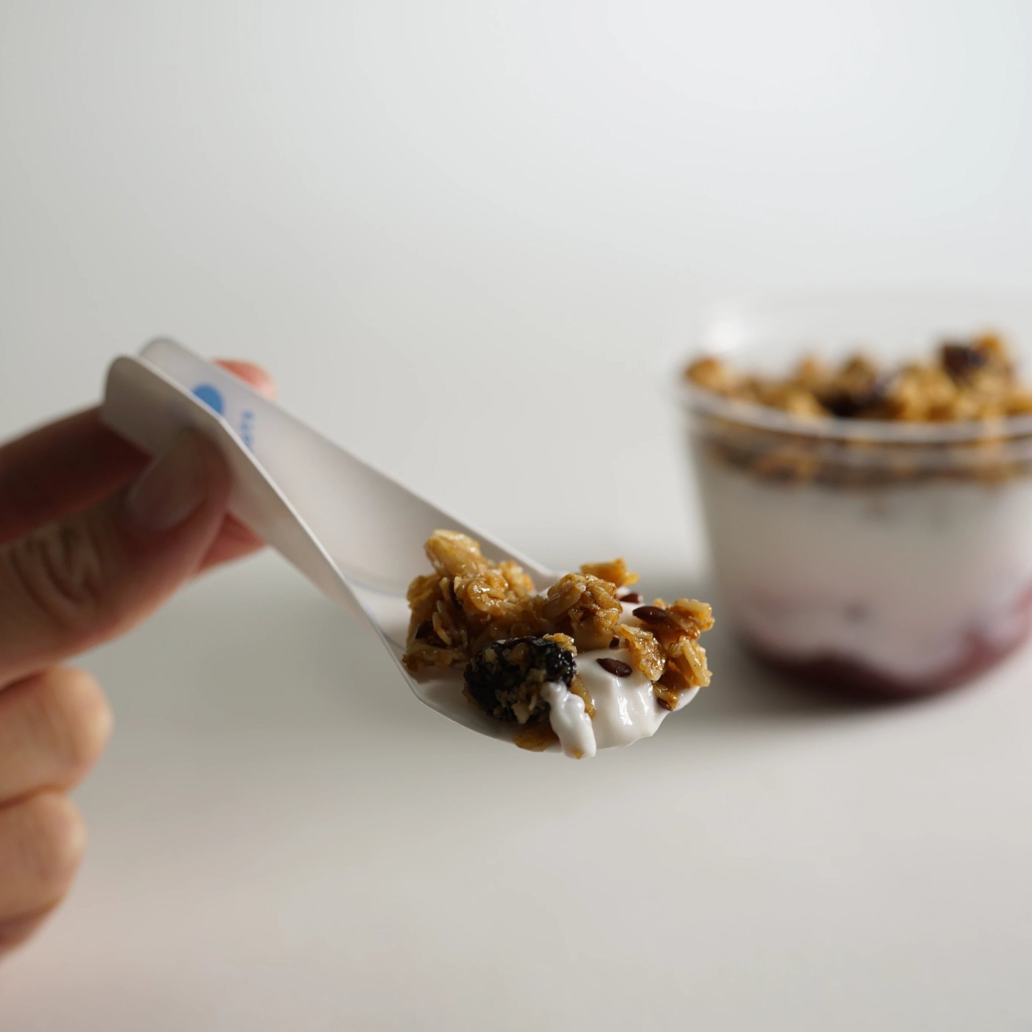The EcoSpoon4 is an eco friendly spoon, about 4” long, shown with full-sized serving of muesli yogurt and oats.
