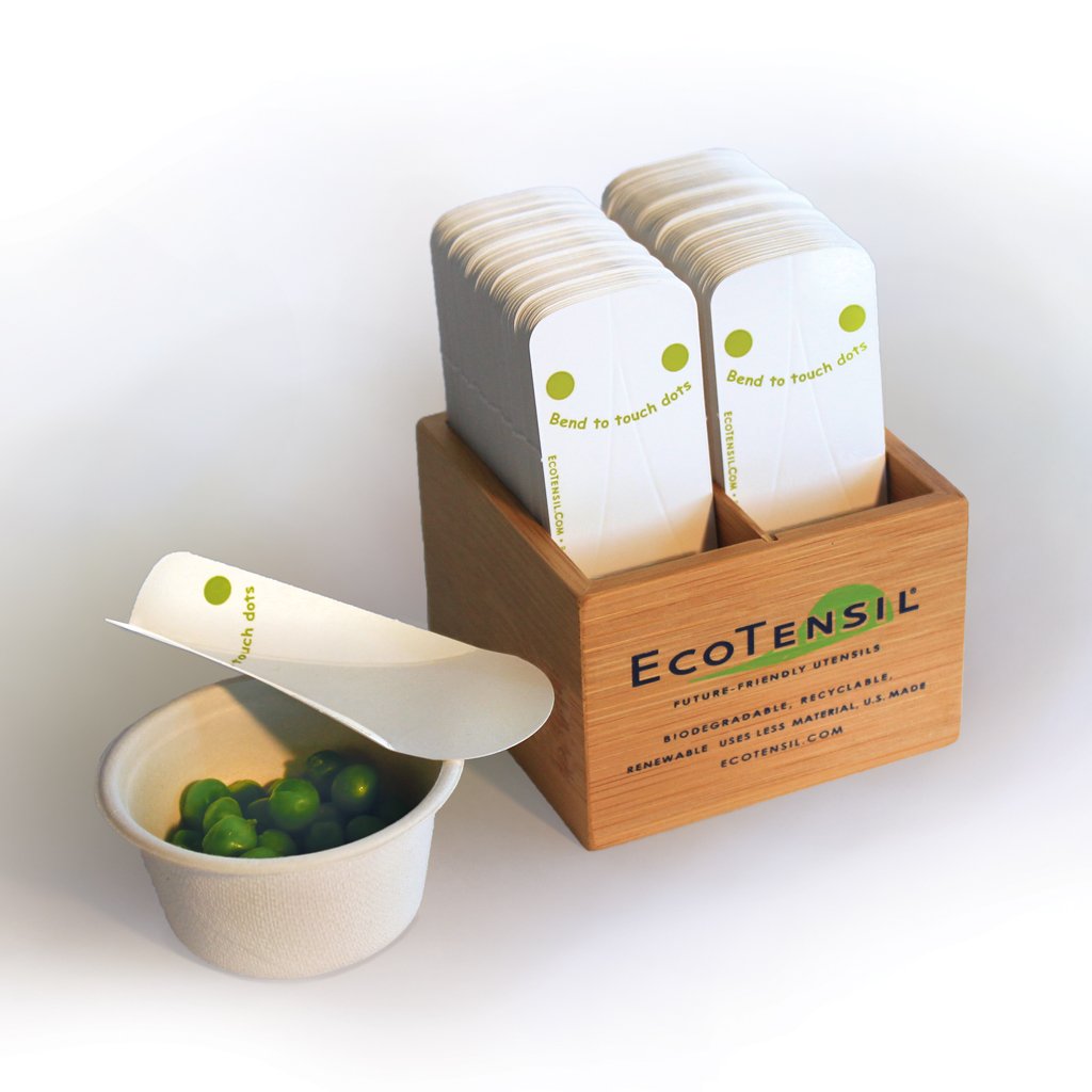 EcoTaster Mini Starter Kit shown with a cup of peas and comes with 1,000 Compostable mini sampling spoons and a bamboo dispenser.